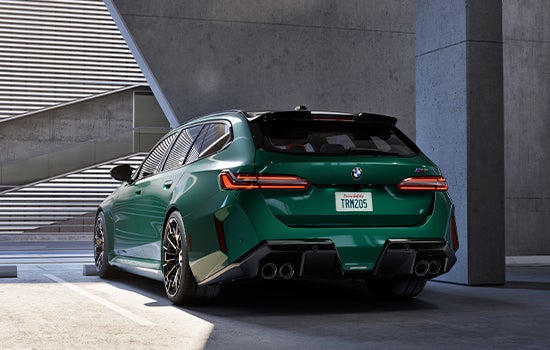 Green BMW M5 Touring parked in garage. | Tom Bush BMW Jacksonville in Jacksonville FL