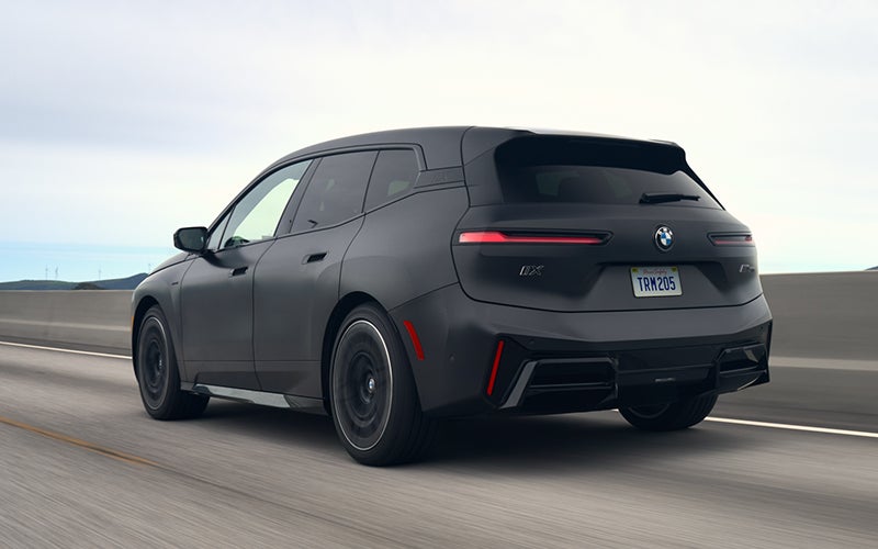 The BMW iX M70 driving rear shot. | Tom Bush BMW Jacksonville in Jacksonville FL
