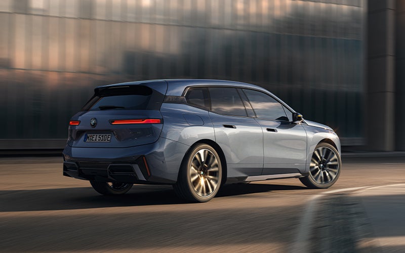 The BMW iX driving with the front wheel turned. | Tom Bush BMW Jacksonville in Jacksonville FL